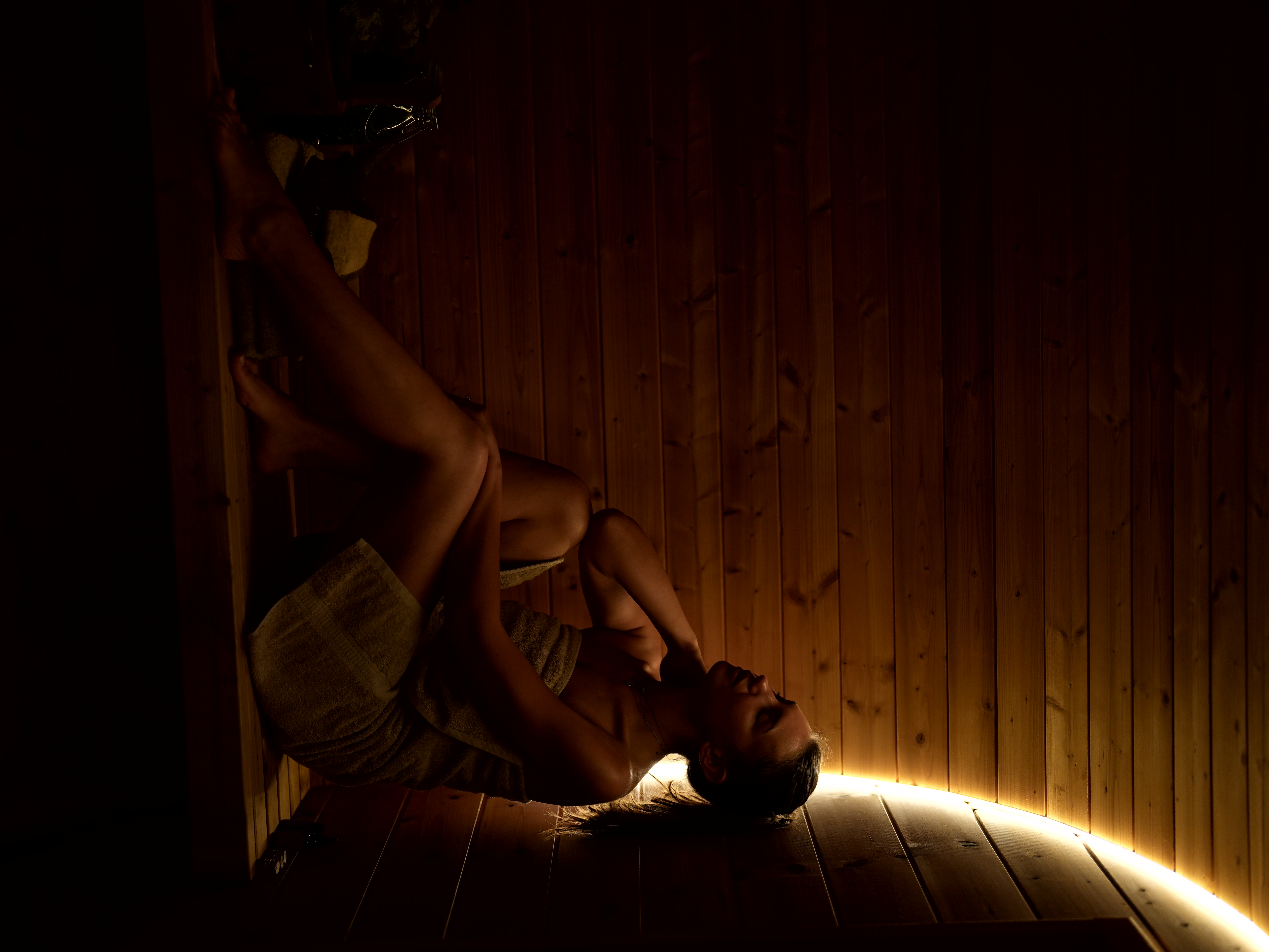 Traditional wood-burning sauna beside the pond